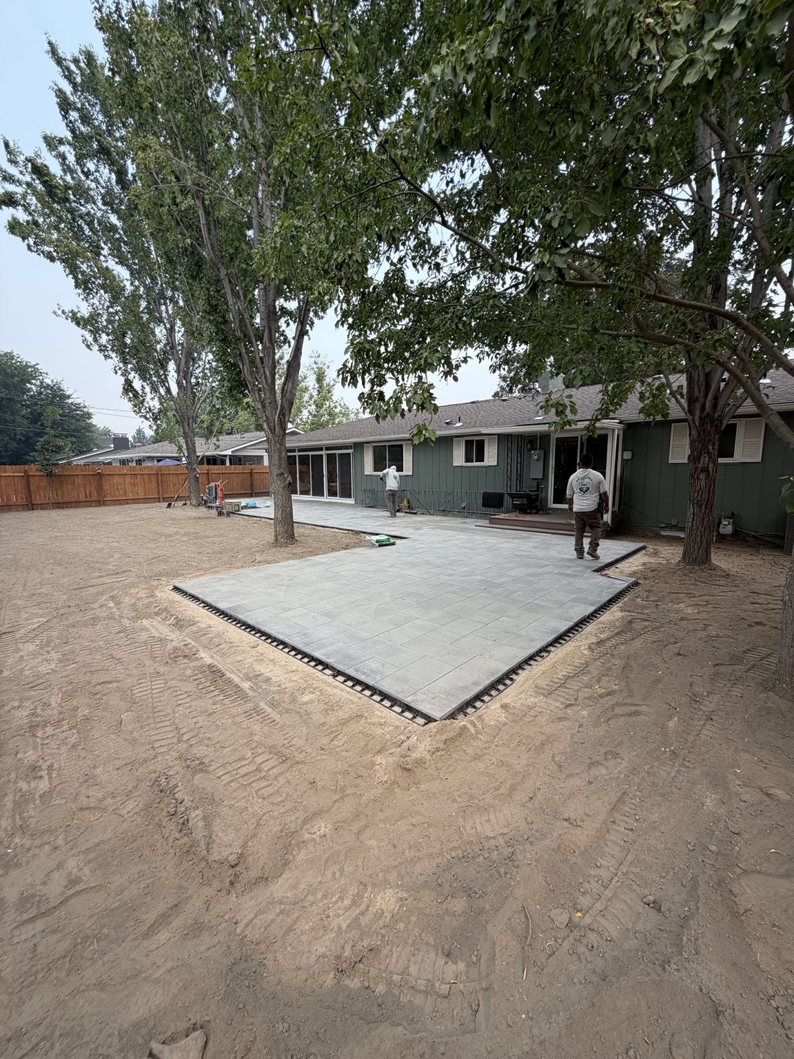 Angled view showing the gray paver patio and connected walkway along the back of the Boise home