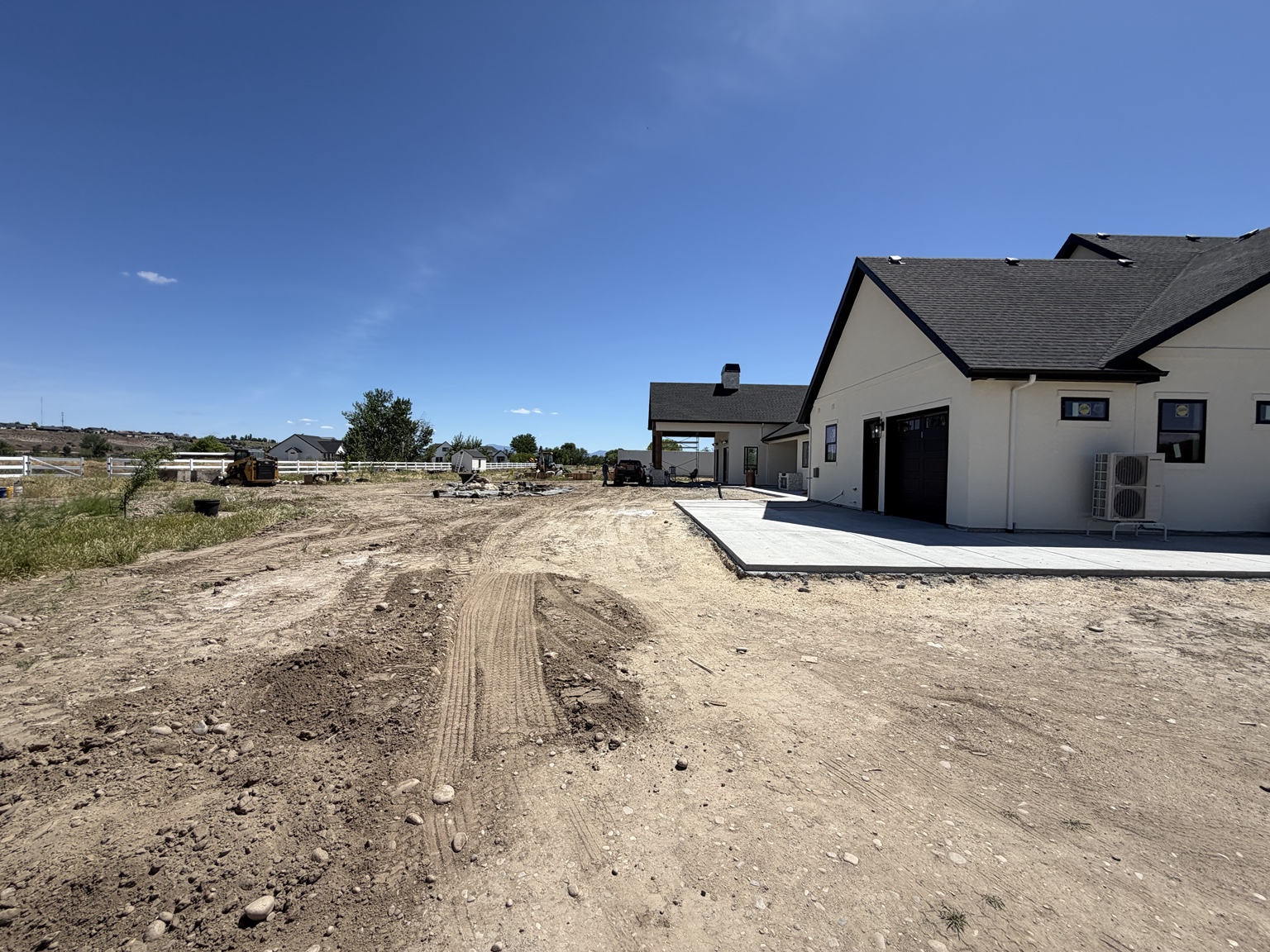 Bare soil around the Middleton home's rear patio before landscaping