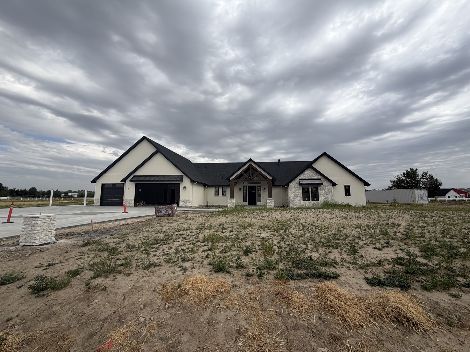Middleton home's front yard with bare soil and weeds before landscaping